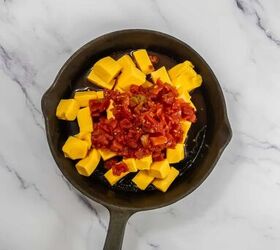 easy beef queso dip with rotel, Velveeta cheese cubes and Rotel tomatoes with green chiles in a skillet