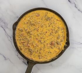 easy beef queso dip with rotel, Melted Velveeta cheese Rotel and seasoned ground beef in a skillet
