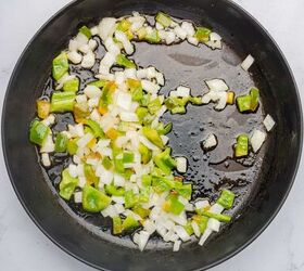 one pot cheesy mexican chicken and rice, Onions and green bell peppers sauteing in a skillet