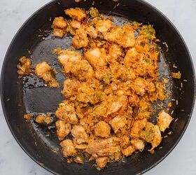 one pot cheesy mexican chicken and rice, Rice and tomato paste added to chicken thighs cooking in the skillet