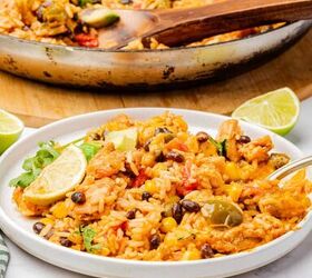 one pot cheesy mexican chicken and rice, Cheesy Mexican chicken and rice on a plate with a spoon and lime wedge