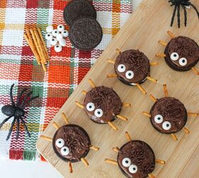 oreo spider cookies recipe for halloween parties, Halloween Oreo spider cookies with candy eyes and pretzel legs arranged on a wooden board with toy spiders and fall napkin