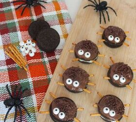 oreo spider cookies recipe for halloween parties, Halloween Oreo spider cookies with candy eyes and pretzel legs on a wooden board with toy spiders