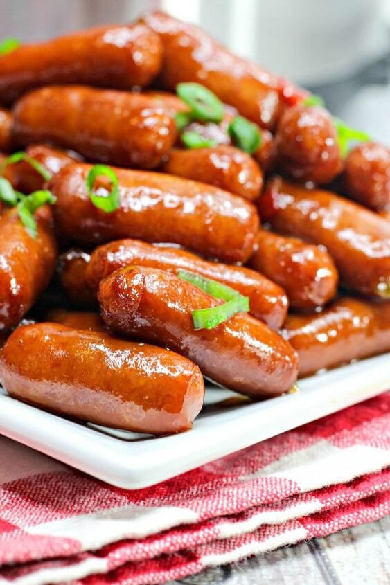crockpot little smokies, a closeup of little smokies on a white plate with a red and white checkered napkin