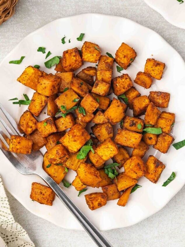 easy 3 ingredient pumpkin muffins with spice cake mix, Top view of crispy roasted sweet potatoes served on a white plate with parsley garnish