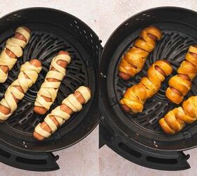 spooky cute air fryer mummy hot dogs kids will love, Mummy hot dogs brushed with egg wash in air fryer basket ready to cook until golden brown