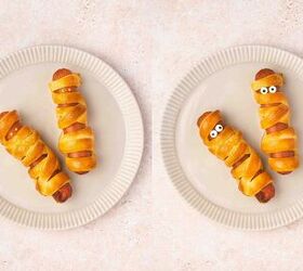 spooky cute air fryer mummy hot dogs kids will love, Golden mummy hot dogs with candy eyes served with small bowl of ketchup and mustard spider web dip