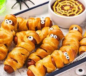 spooky cute air fryer mummy hot dogs kids will love, Crispy mummy hot dogs on a platter served with small bowls of ketchup and mustard for dipping