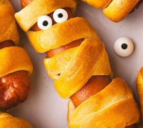 easy vampire kiss cocktail recipe for halloween 2025, Close up of a golden Air Fryer Mummy Hot Dog showing crescent roll bandages and candy eyes