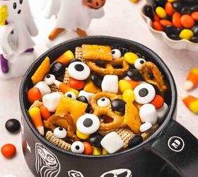 spooky halloween snack mix easy kid friendly recipe, Spooky Halloween snack mix with Chex Cheez Its pretzels candy corn mini marshmallows candy coated chocolates and candy eyes served in a black Halloween themed bowl