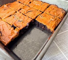 pumpkin cheesecake brownies recipe for fall desserts, Pumpkin brownies with one piece removed from the pan showing the fudgy chocolate brownie layer inside