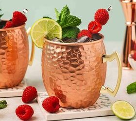 easy raspberry moscow mule party ready mint cocktail, Festive Raspberry Moscow Mule with lime and mint garnish on a wooden table