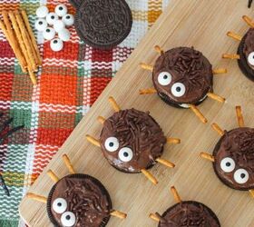 perfectly moist cream cheese pumpkin bread recipe, Halloween Oreo spider cookies with candy eyes and pretzel legs arranged on a wooden board with toy spiders and fall napkin