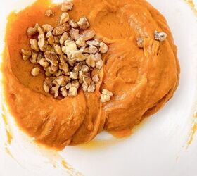 perfectly moist cream cheese pumpkin bread recipe, Pumpkin bread batter in a mixing bowl topped with chopped walnuts before folding together