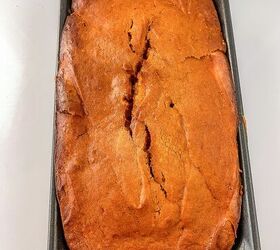 perfectly moist cream cheese pumpkin bread recipe, Close up of baked cream cheese pumpkin bread in the pan showing a cracked golden crust