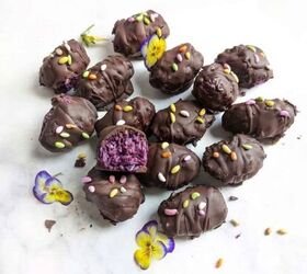chocolate bounty blueberry bites, Chocolate Bounty Blueberry Bites wit one half eaten and decorated with edible flowers