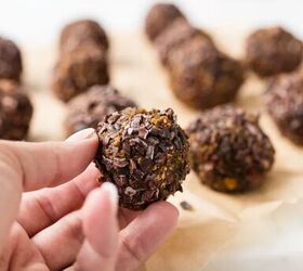 pumpkin spice protein energy balls, hand holding up a pumpkin spice energy bite