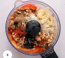 muhammara recipe roasted red pepper dip gf, A food processor bowl filled with walnuts spices minced garlic and roasted red peppers ready to be blended for a vibrant muhammara recipe The colorful textured mixture is viewed from above A white circle with the number 3 is in the corner