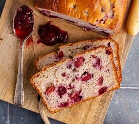 cranberry sauce bread, Cranberry Sauce Bread on a cutting board from above with a spoon of leftover sauce