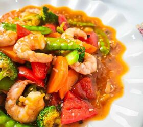 homemade shrimp and vegetable stir fry in 30 minutes, Close up of shrimp and vegetable stir fry showing vibrant broccoli carrots and snap peas in a glossy sauce