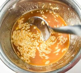 homemade shrimp and vegetable stir fry in 30 minutes, Stirring homemade stir fry sauce with sesame seeds in a mixing bowl