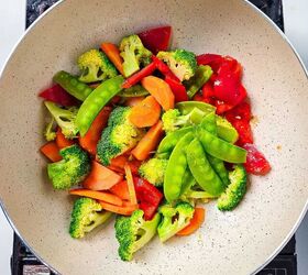 homemade shrimp and vegetable stir fry in 30 minutes, Fresh broccoli carrots bell peppers and snap peas added to wok for stir fry