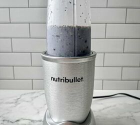 blueberry protein shake, A blue liquid with blueberries almond milk chia seeds and Brazil nuts in a Nutribullet blender