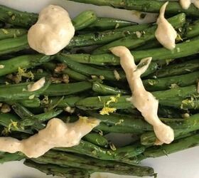 mediterranean roasted zucchini slices, green beans with a lemon tahini dressing on a white plate