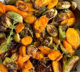 mediterranean roasted zucchini slices, Sliced and roasted Brussels sprouts and carrots in a white bowl with a spoon