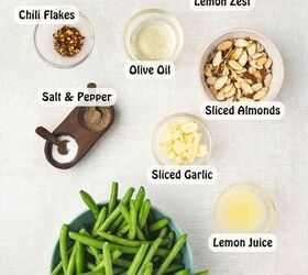 easy oven roasted green beans with garlic and lemon, Garlic roasted green beans topped with toasted almonds and lemon slices on a baking sheet served as a healthy holiday side dish