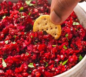 easy cranberry jalapeno salsa holiday dip made with frozen cranberri, Hand scooping cranberry jalape o salsa with a multigrain cracker