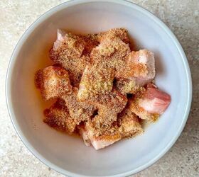 air fryer pork belly crispy bites, Pork belly bites in a mixing bowl with brown sugar and seasonings