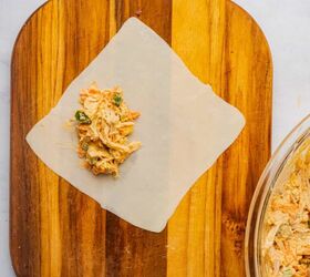 buffalo chicken egg rolls air fryer recipe, Buffalo chicken filling at the bottom corner of an egg roll wrapper