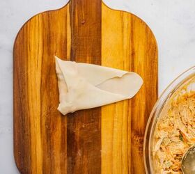 buffalo chicken egg rolls air fryer recipe, Egg roll wrapped on a cutting board