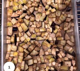 sicilian caponata with raisins celery fresh herbs, A baking tray filled with evenly spread uncooked diced eggplant pieces perfect for Sicilian caponata ready for roasting The eggplant cubes vary in size and color from pale yellow to deep purple