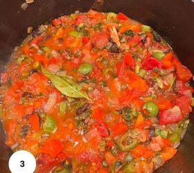 sicilian caponata with raisins celery fresh herbs, A pot filled with Sicilian caponata a chunky tomato based stew featuring diced tomatoes onions green olives capers red peppers and a bay leaf simmering together in a rich sauce