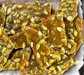 best pumpkin seeds brittle sweet nutty crunchy, Pumpkin seed brittle pieces stacked on parchment paper showing glossy caramel coating and green pumpkin seeds