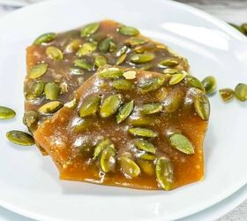 best pumpkin seeds brittle sweet nutty crunchy, Pumpkin seed brittle triangle pieces on a white plate with autumn decor in the background