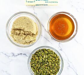 best pumpkin seeds brittle sweet nutty crunchy, Top view of ingredients for pumpkin seed brittle including butter brown sugar honey and pepitas arranged on a marble surface