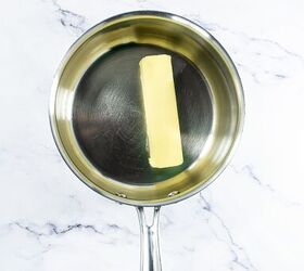 best pumpkin seeds brittle sweet nutty crunchy, Stick of butter melting in a stainless steel saucepan on a marble countertop