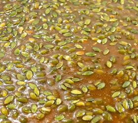 best pumpkin seeds brittle sweet nutty crunchy, Close up of glossy pumpkin seed brittle with a golden caramel coating