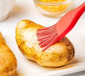 loaded baked potato with brisket, Brushing olive oil on a russet baking potato
