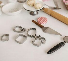 tulumba recipe make a delicious turkish donut at home in 1 hour, Selection of baking tools with cookie cutters and dough on a white surface perfect for creative baking