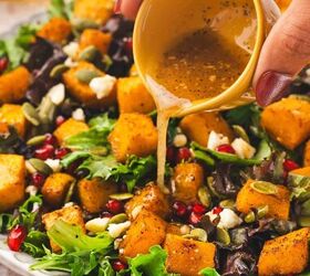 easy roasted butternut squash feta salad holiday side salad, Close up of dressing being poured over a festive roasted squash and feta salad