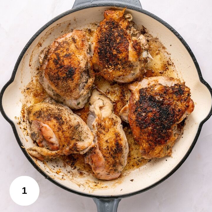 juicy chicken marsala thighs gf one skillet, Five seasoned browned chicken thighs cook in a round white enameled skillet with a gray handle sitting on a light surface This one skillet meal makes the chicken appear crispy and perfectly cooked