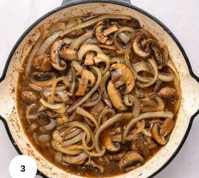 juicy chicken marsala thighs gf one skillet, Sliced mushrooms and onions cooked in a brown sauce fill a white skillet with a black rim creating a classic Chicken Marsala look on a light countertop perfect for a one skillet gluten free meal