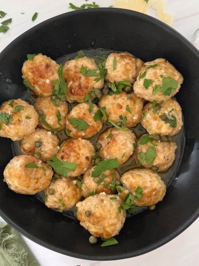juicy chicken marsala thighs gf one skillet, Chicken Piccata Meatballs in a black skillet with a spoon on the side