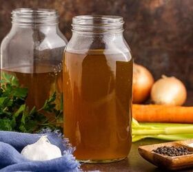crock pot vegetable stock, Crock Pot Vegetable Stock in mason jars on a counter with carrots and celery and other veggies