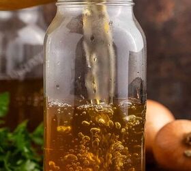 crock pot vegetable stock, Crock Pot Vegetable Stock being poured into a mason jar