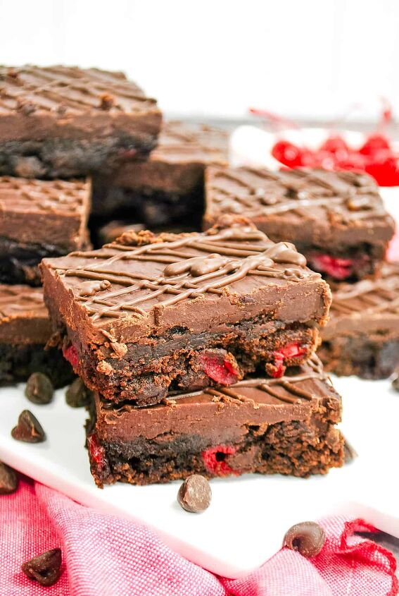 cherry brownies, two chocolate cherry brownies stacked on top of each other and topped with chocolate ganache